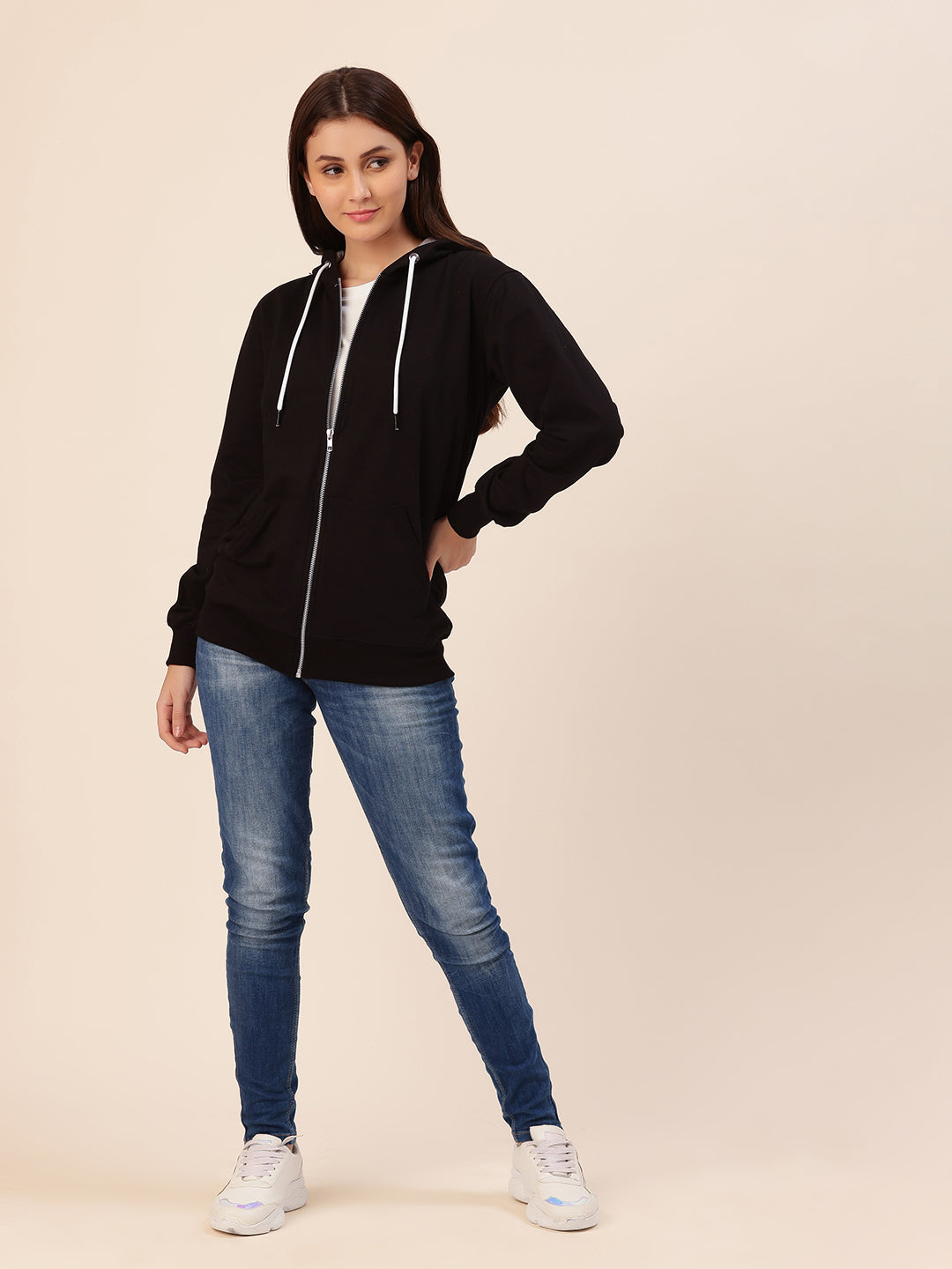 Lifestyle shot of woman wearing black cotton fleece hoodie