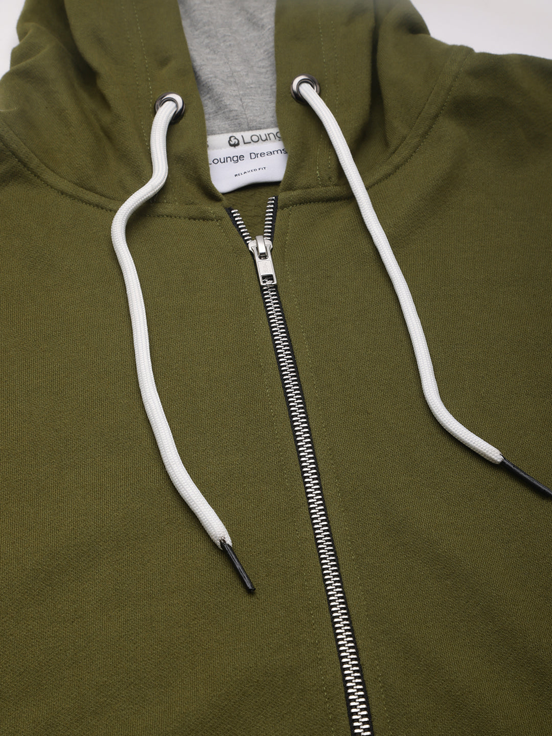Full outfit shot styled with olive hoodie