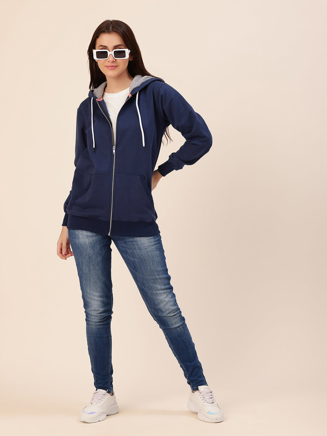 Lifestyle shot of woman wearing navy cotton fleece hoodie
